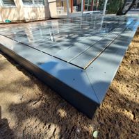 Close-up of a wet composite deck reflecting sunlight, emphasizing the water-resistant quality of materials used by decking experts in Palm Bay.