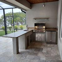 Luxurious outdoor kitchen with modern stainless steel appliances and a spacious granite countertop in Palm Bay, Florida