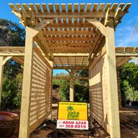 Sturdy pergola constructed by Palm Bay's finest, with a 'Custom work done by' sign, showcasing quality craftsmanship in Brevard County.